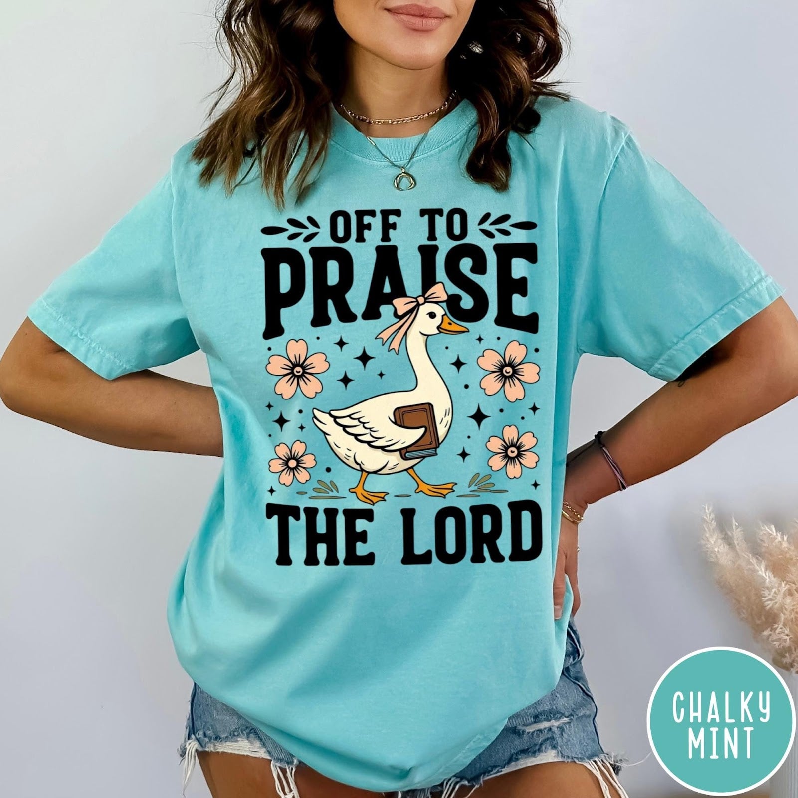 Comfort Colors tee in Chalky Mint featuring screen print style graphic of a goose carrying a book