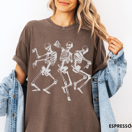 Comfort Colors tee in Espresso featuring dancing skeletons graphic illustration on the front of the shirt