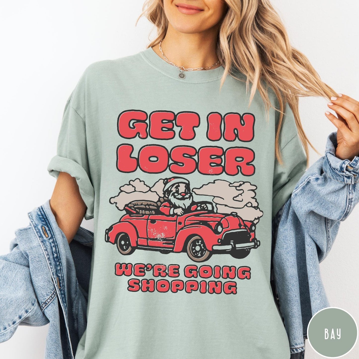 Comfort Colors tee in Bay featuring retro style graphic of Santa Claus driving a red convertible car