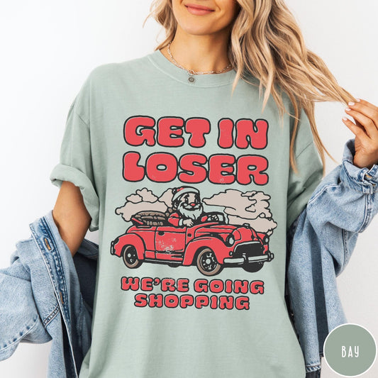 Comfort Colors tee in Bay featuring retro style graphic of Santa Claus driving a red convertible car