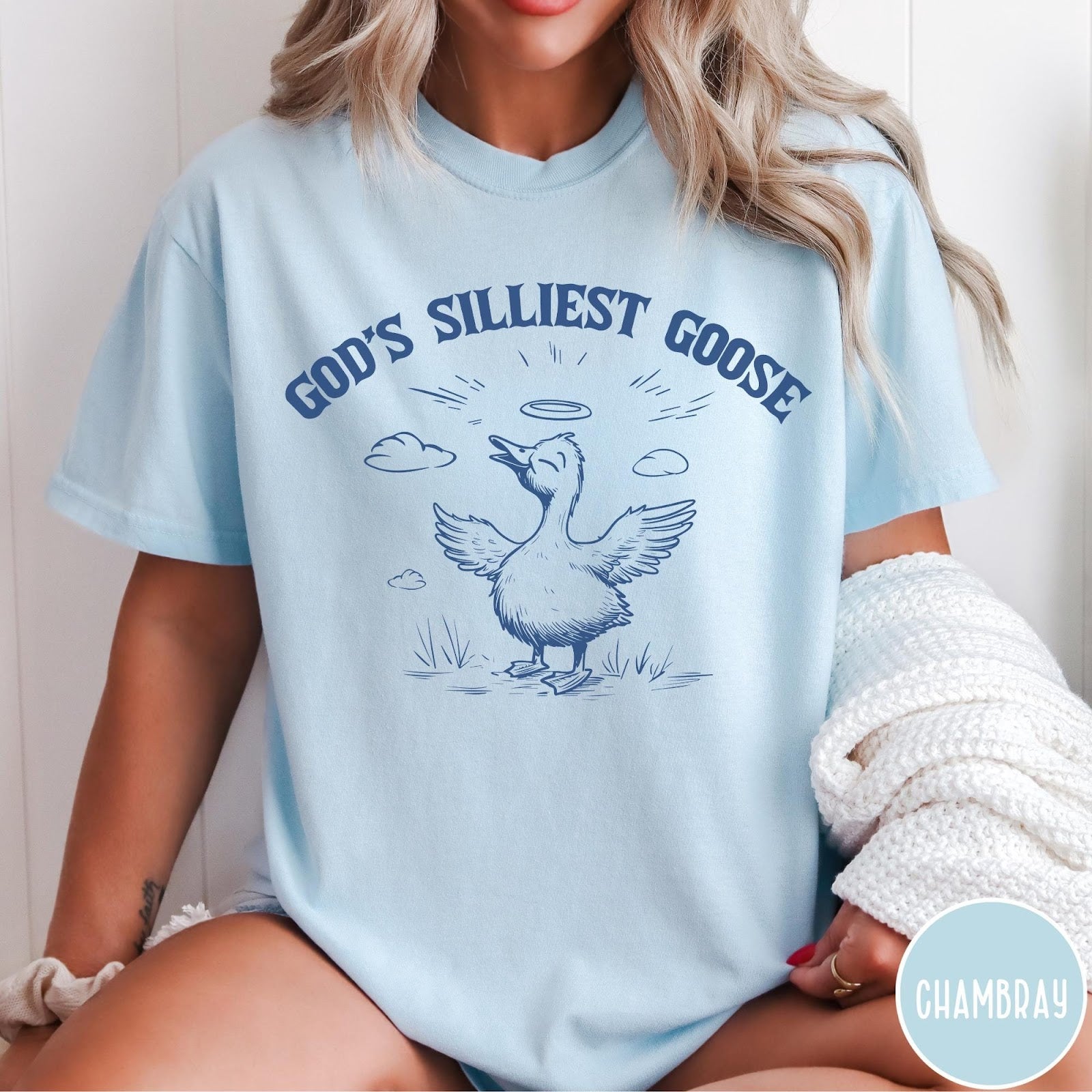 Comfort Colors tee in Chambray featuring line art graphic of a goose with a halo and wings