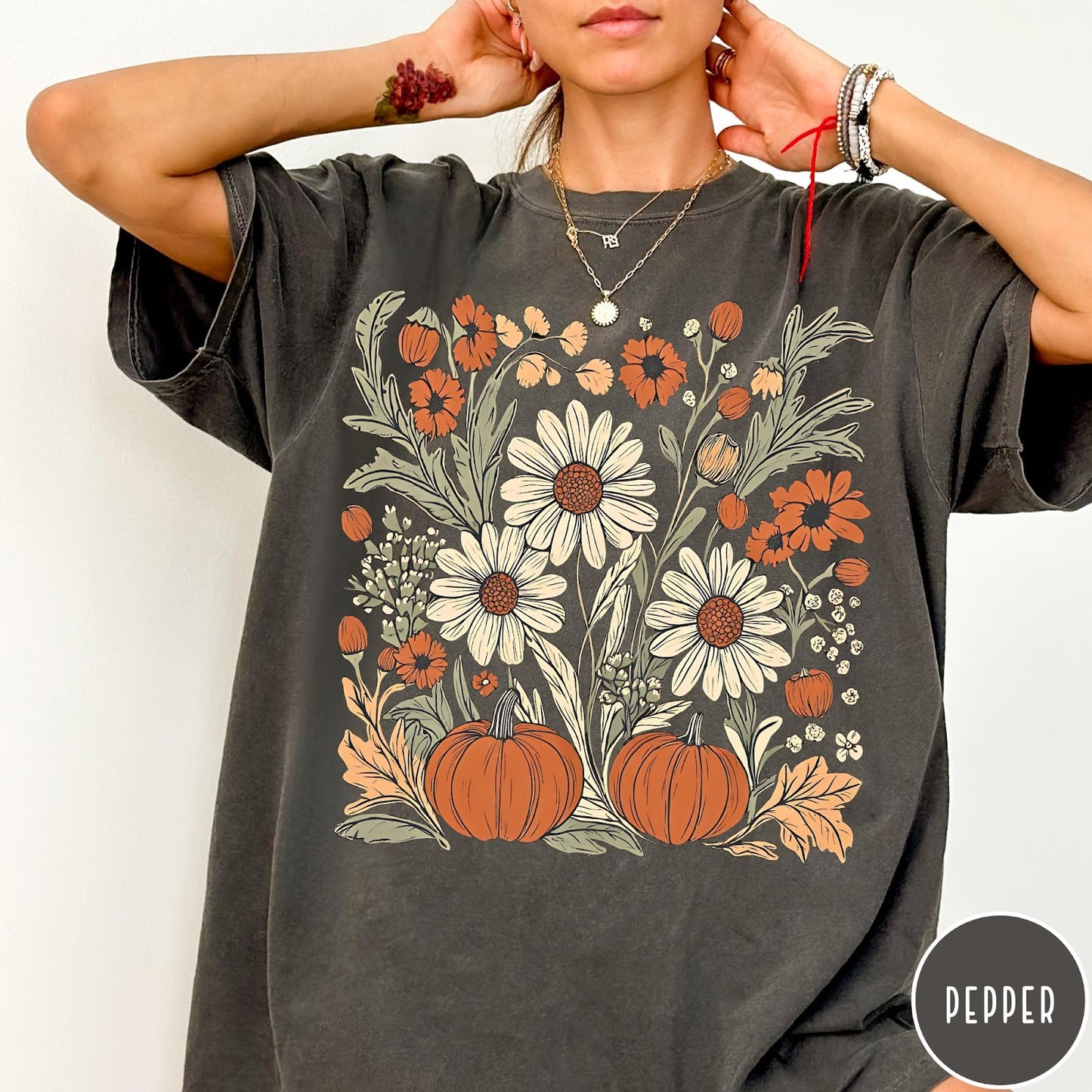 Comfort Colors tee in Pepper featuring boho floral design with pumpkins and daisies in fall colors