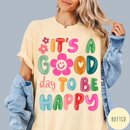 Comfort Colors tee in Butter featuring typography and floral elements with a smiley face graphic design