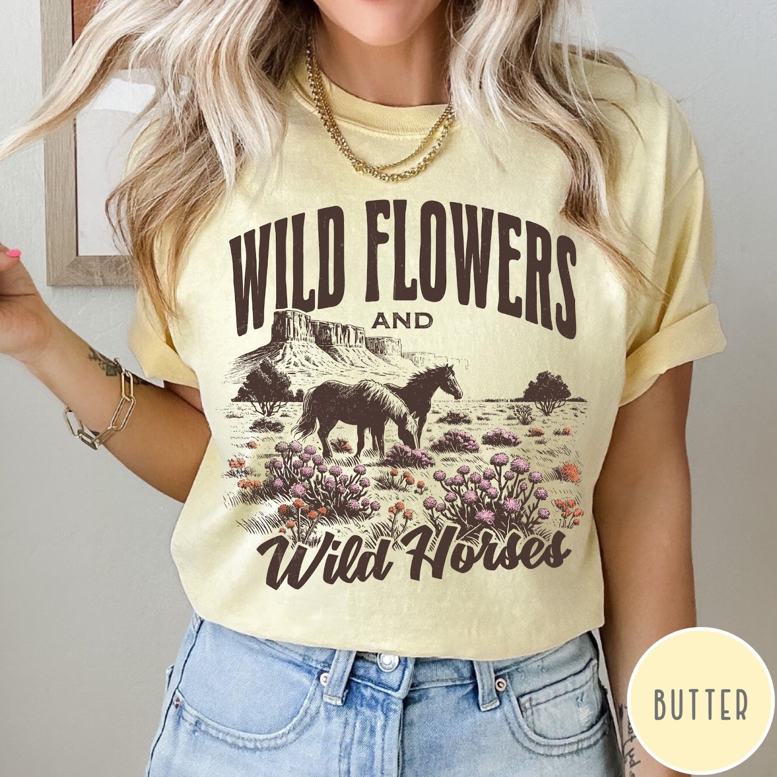 Comfort Colors tee in Butter featuring western style graphic of wild horses grazing in a wildflower field