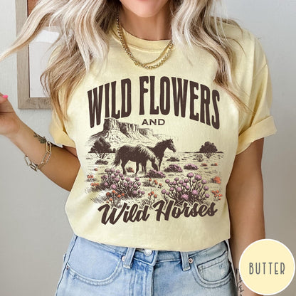 Comfort Colors tee in Butter featuring western style graphic of wild horses grazing in a wildflower field