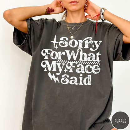 Comfort Colors tee in Pepper featuring sarcastic expression graphic with Sorry For What My Face Said text