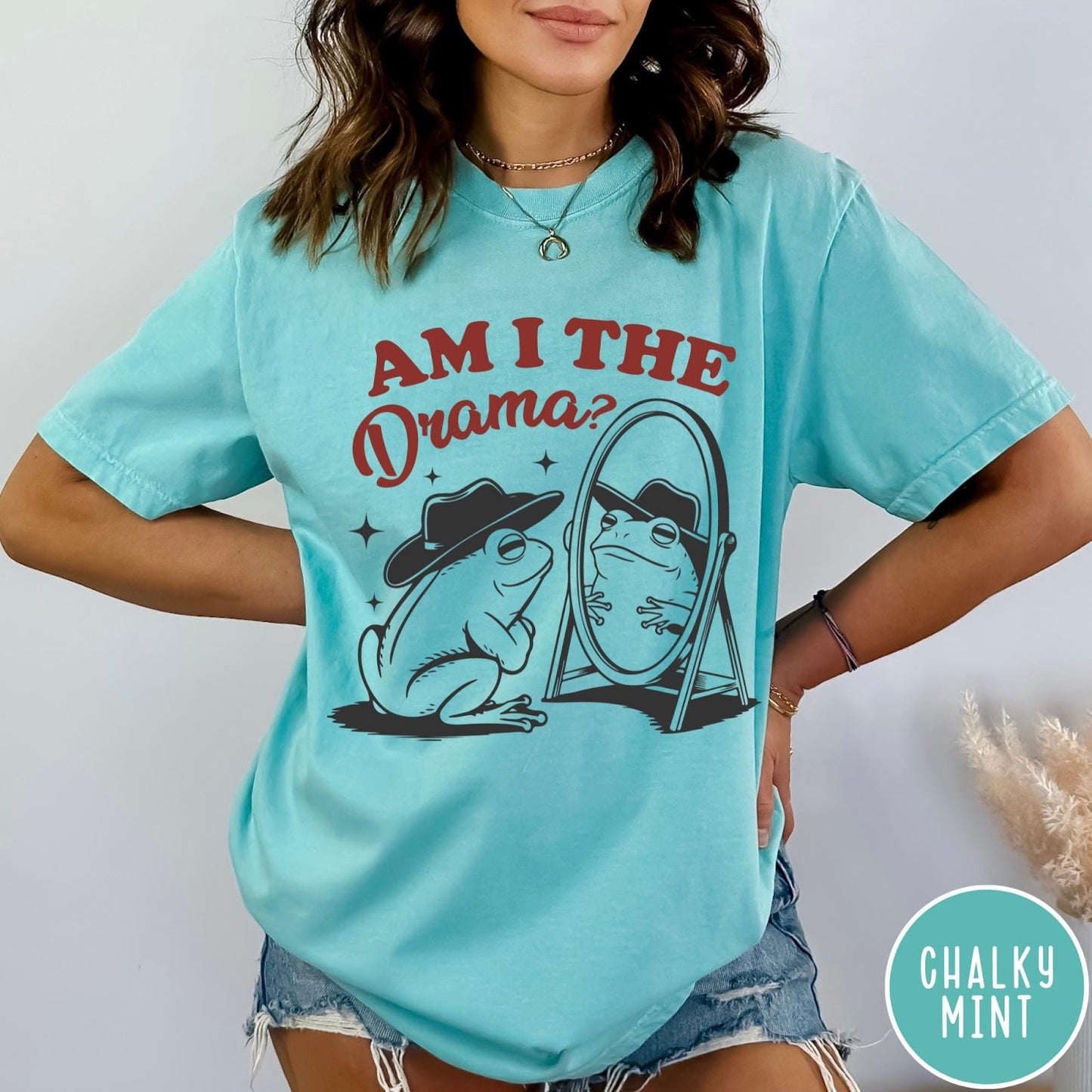 Comfort Colors tee in Chalky Mint featuring whimsical frog graphic with a cowboy hat looking into a mirror