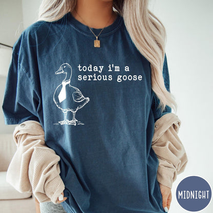 Comfort Colors tee in Midnight featuring minimalist graphic design of a goose wearing a necktie and text