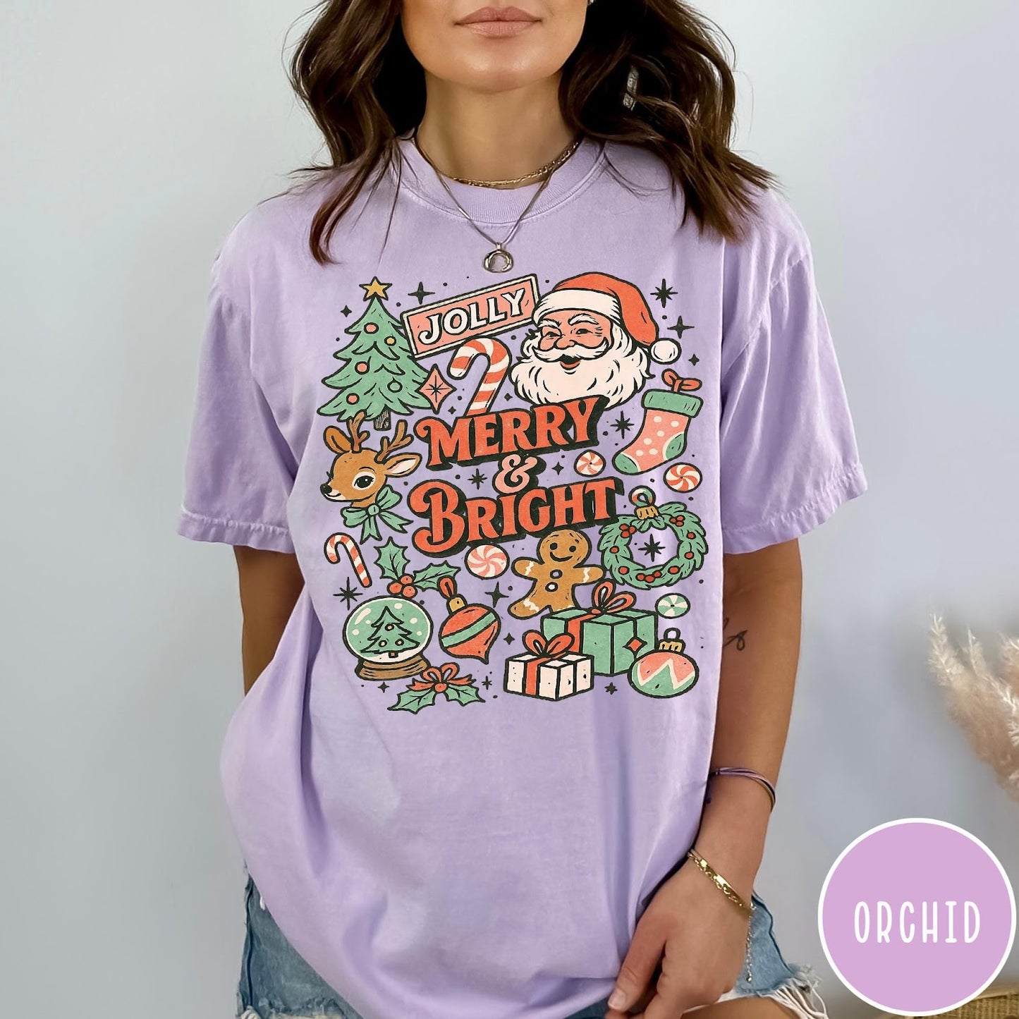 Comfort Colors tee in Orchid featuring retro holiday style graphic with Santa, reindeer, and Christmas icons
