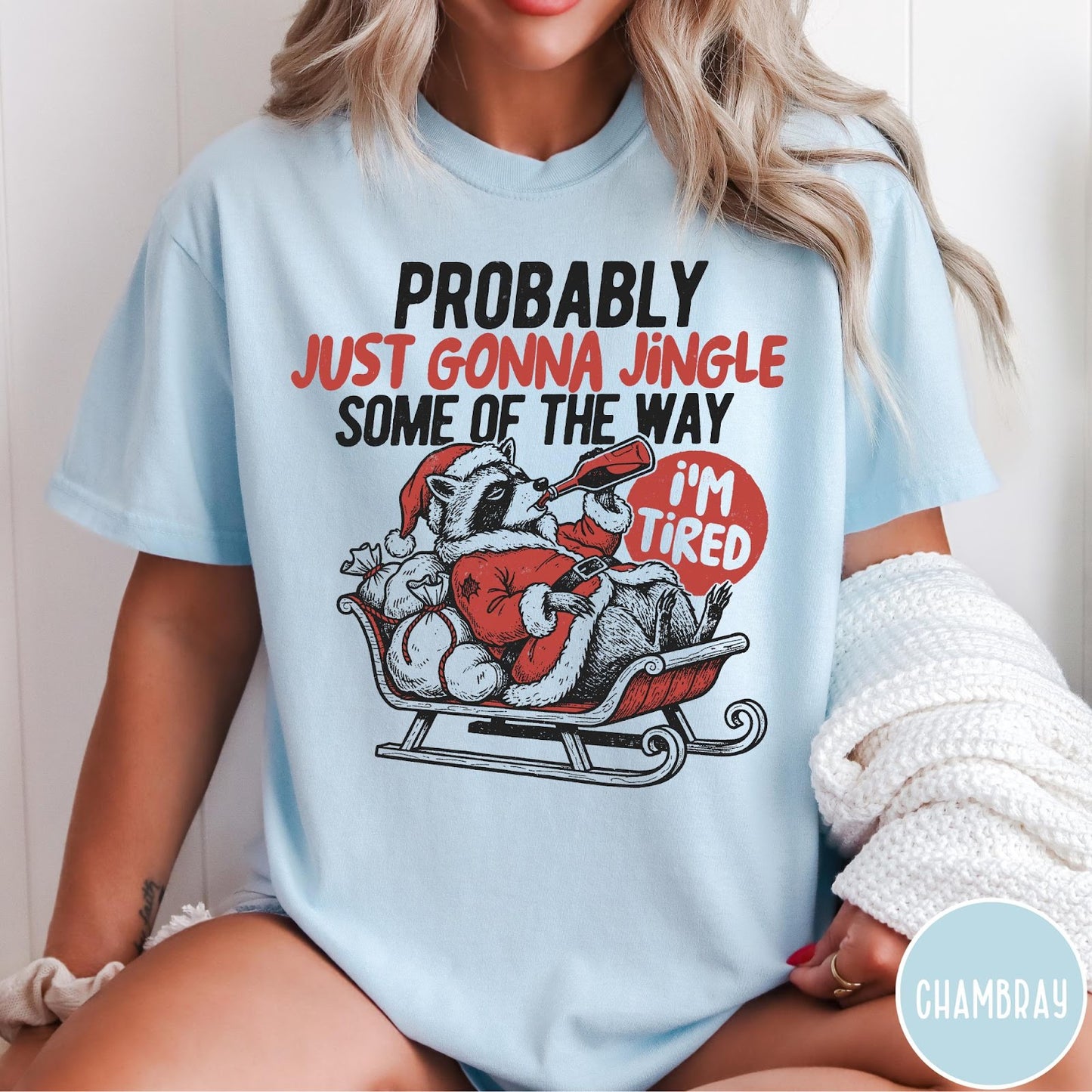 Comfort Colors tee in Chambray featuring vintage style graphic of a tired raccoon in a Santa sleigh