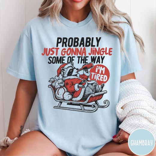 Comfort Colors tee in Chambray featuring vintage style graphic of a tired raccoon in a Santa sleigh
