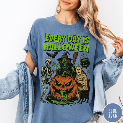 Comfort Colors tee in Blue Jean featuring Halloween graphic with a witch, skeleton, ghost, and a dripping pumpkin.