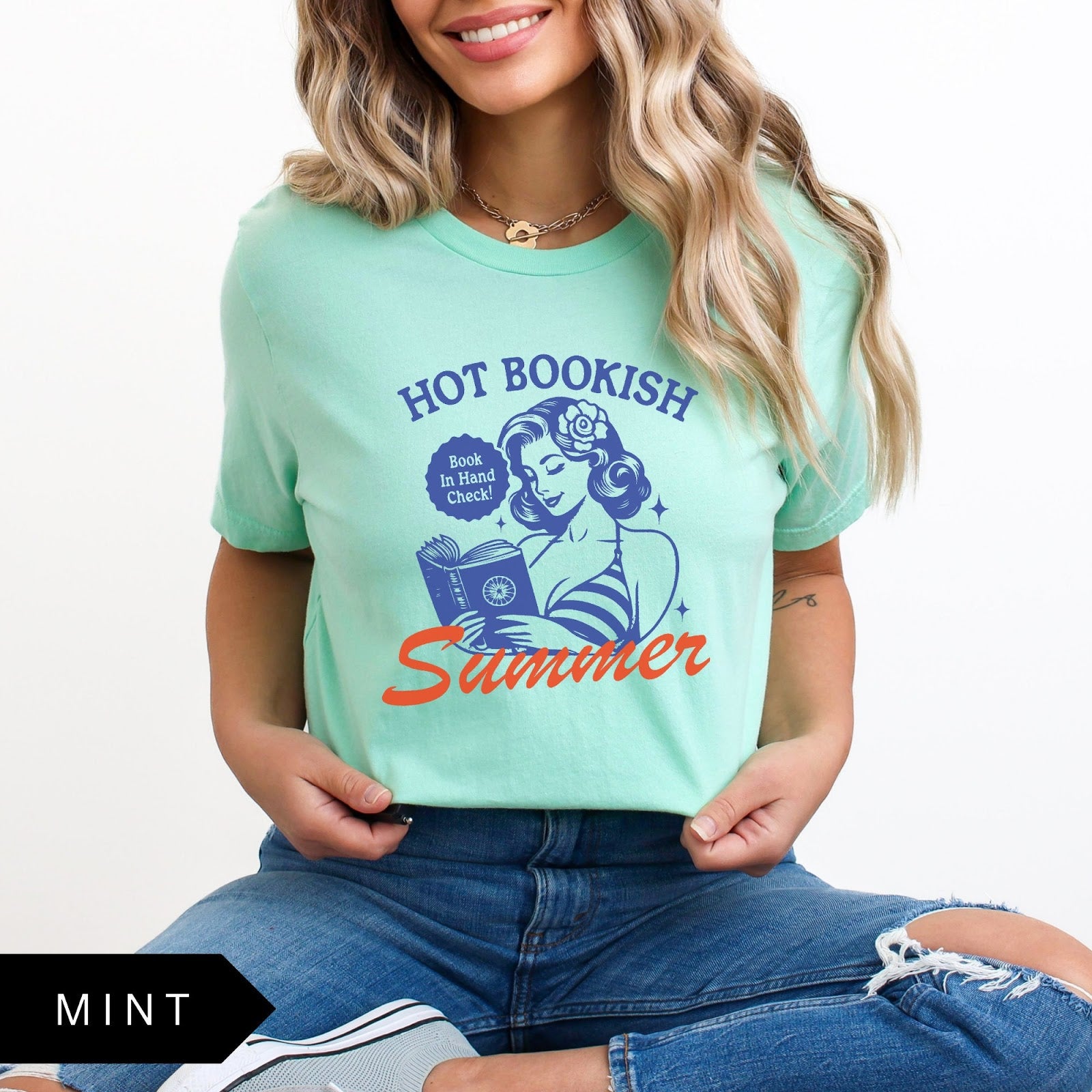 Comfort Colors tee in Mint featuring pinup girl reading a book graphic design with blue and orange ink