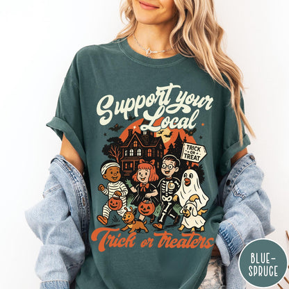 Comfort Colors tee in Blue Spruce featuring vintage style trick or treaters graphic with a haunted house background