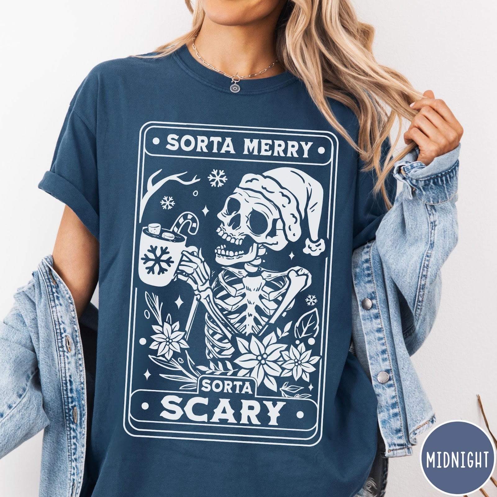 Comfort Colors tee in Midnight featuring graphic design of a skeleton in a Santa hat holding cocoa