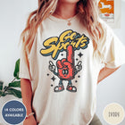 Comfort Colors tee in Ivory featuring retro mascot design with a red foam finger and Go Sports text