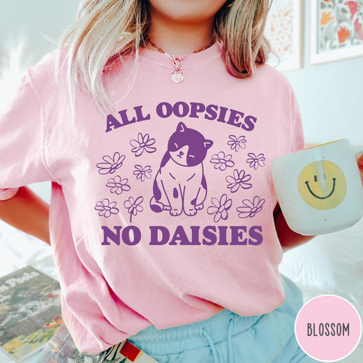 Comfort Colors tee in Blossom featuring cute cat graphic with purple text reading All Oopsies No Daisies