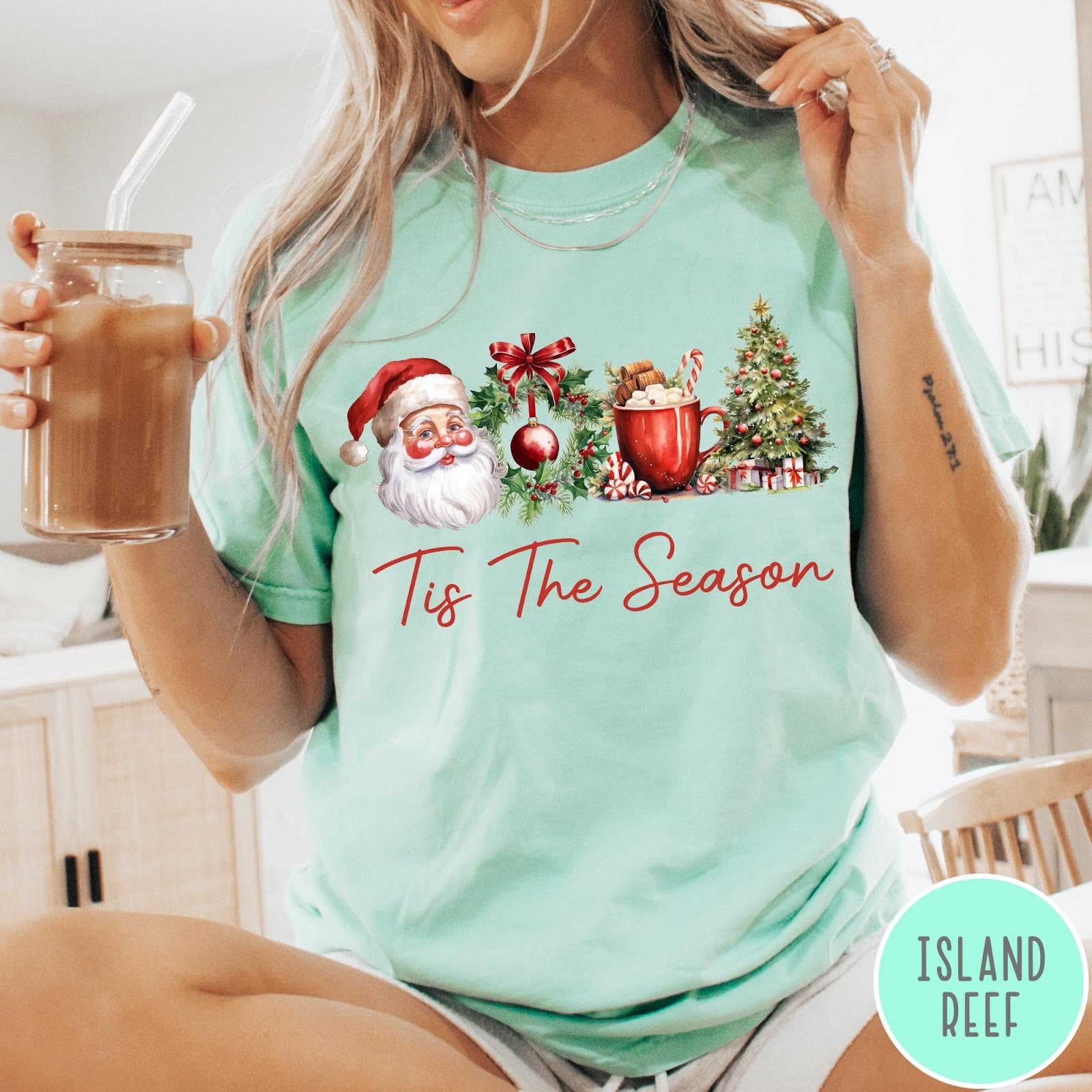 Comfort Colors tee in Island Reef featuring holiday design with Santa, wreath, hot cocoa, and Christmas tree graphic