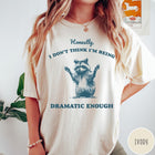 Comfort Colors tee in Ivory featuring vintage style graphic of a raccoon with arms raised and text