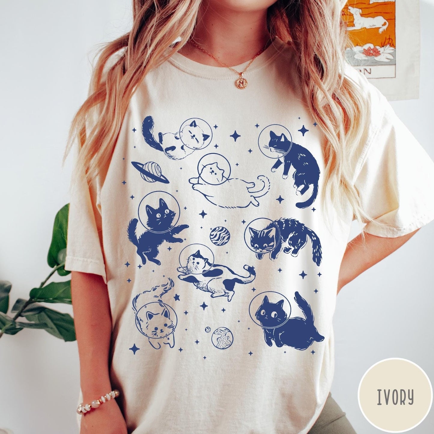Comfort Colors tee in Ivory featuring whimsical space style graphic with multiple cats floating in space helmets