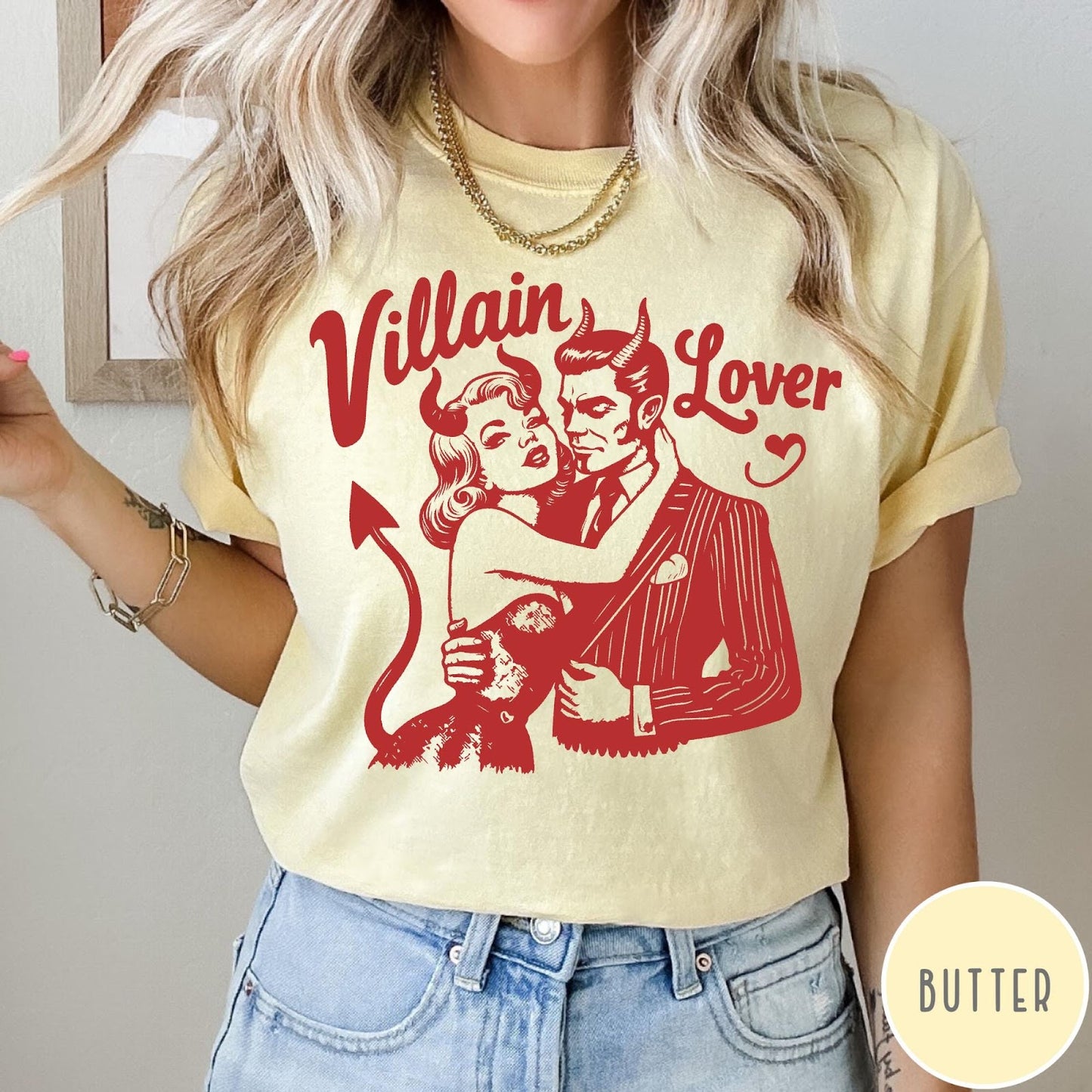 Comfort Colors tee in Butter featuring vintage style graphic of a devilish couple embracing with red ink