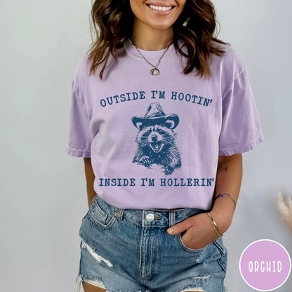 Comfort Colors tee in Orchid featuring western style graphic of a raccoon wearing a cowboy hat