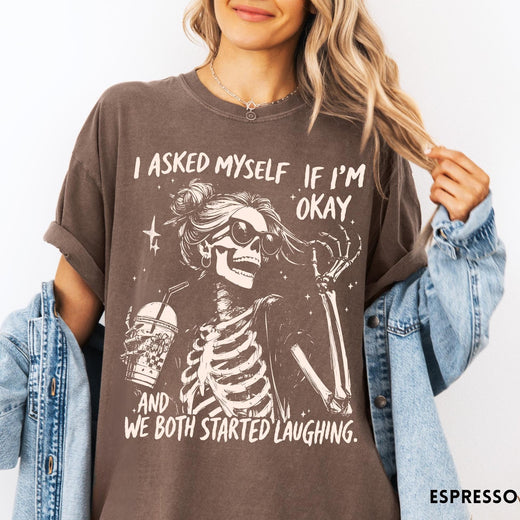 Comfort Colors tee in Espresso featuring skeleton design with sunglasses and iced coffee with laughing text graphic