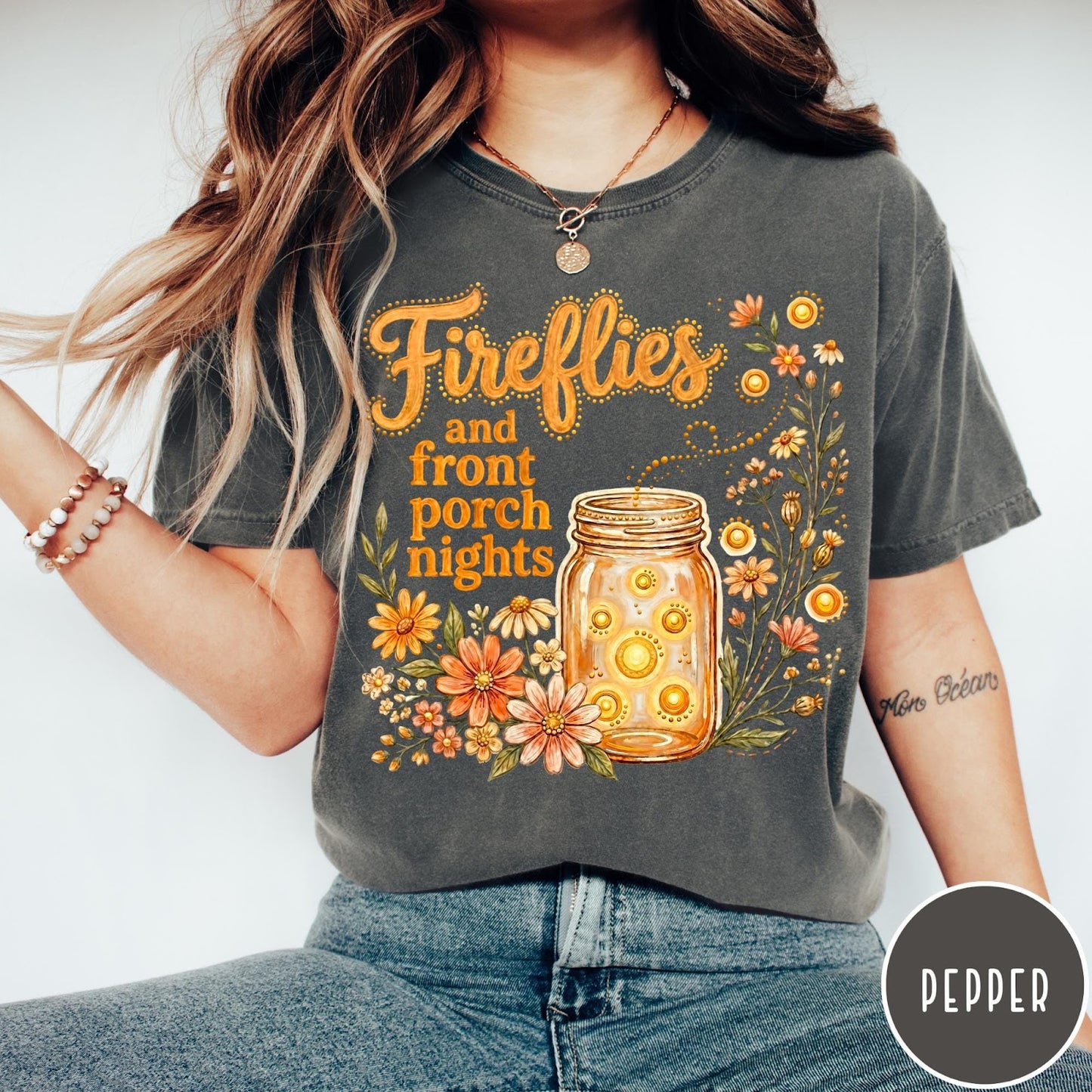 Comfort Colors tee in Pepper featuring whimsical graphic design of fireflies in a mason jar with wildflowers