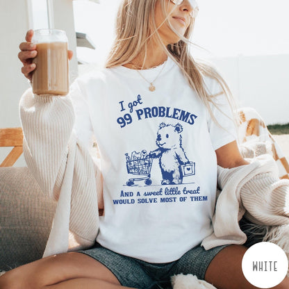 Comfort Colors tee in White featuring graphic design of a bear pushing a shopping cart with treats