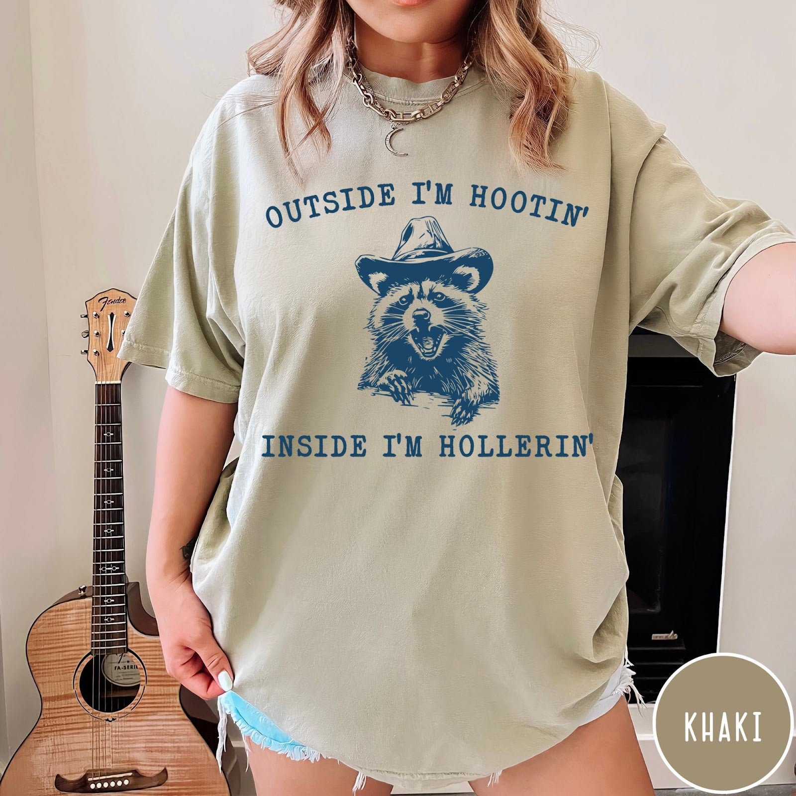 Comfort Colors tee in Khaki featuring western style graphic of a raccoon wearing a cowboy hat