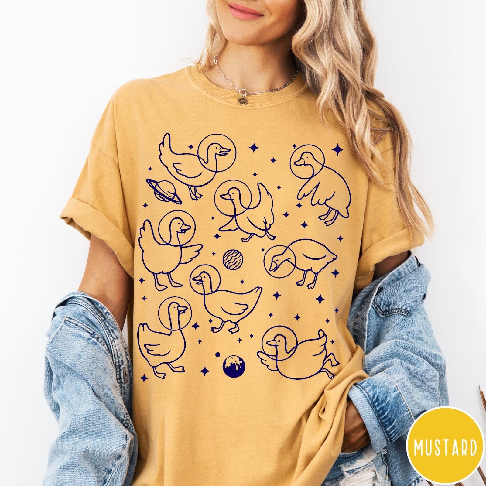 Comfort Colors tee in Mustard featuring line art graphic of multiple geese wearing astronaut helmets in space