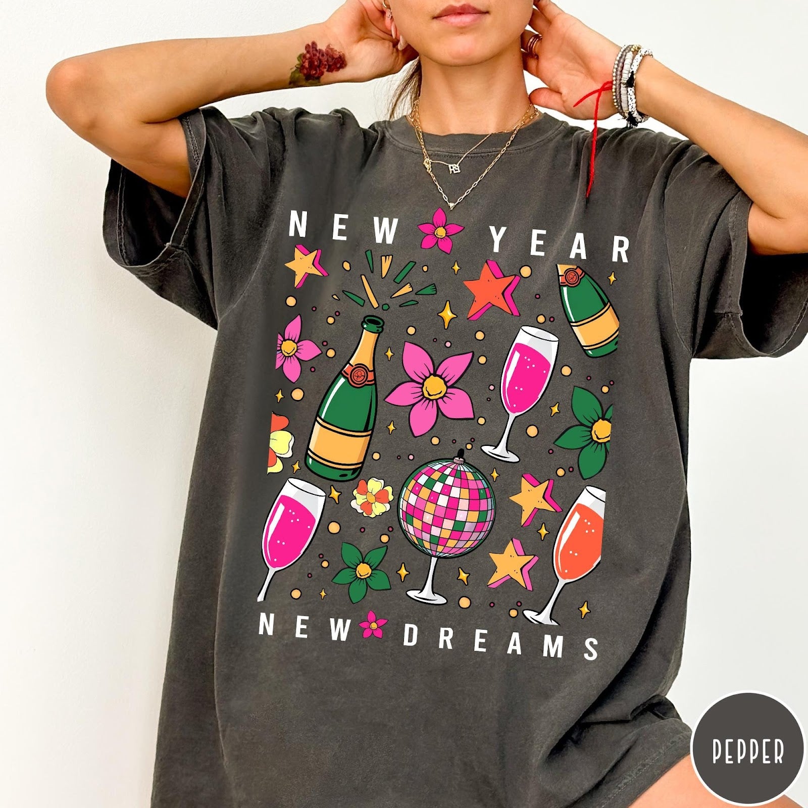 Comfort Colors tee in Pepper featuring New Year celebration graphic with champagne bottles, glasses, and disco ball