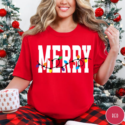 Comfort Colors tee in Red featuring holiday style graphic with white Merry text and colorful Christmas lights