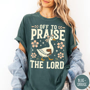 Comfort Colors tee in Blue Spruce featuring retro style graphic of a goose wearing a bow holding a book