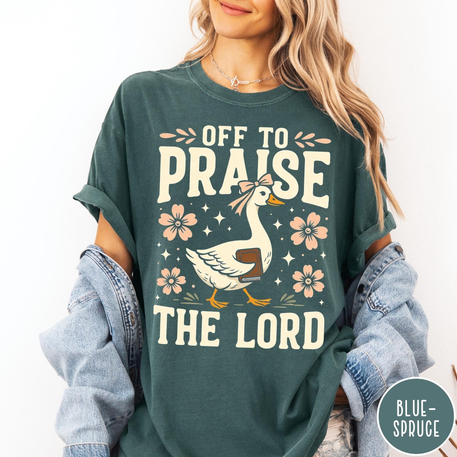 Comfort Colors tee in Blue Spruce featuring retro style graphic of a goose wearing a bow holding a book