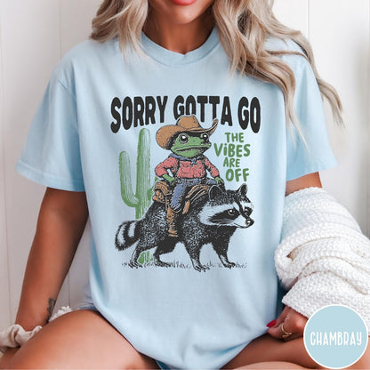 Comfort Colors tee in Chambray featuring western graphic of a cowboy frog riding a raccoon with cactus
