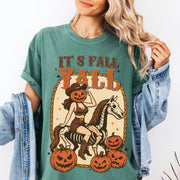 Comfort Colors tee in Sage featuring western graphic of a pumpkin cowgirl riding a skeleton horse with pumpkins
