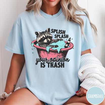 Comfort Colors tee in Chambray featuring illustrative graphic of a raccoon sitting in a pink bathtub