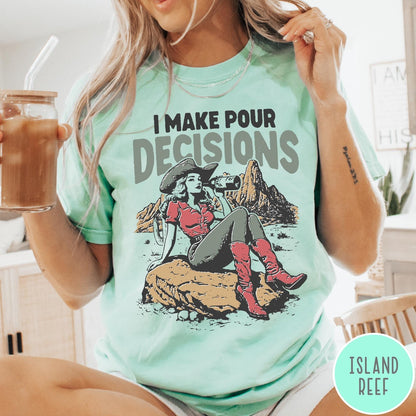 Comfort Colors tee in Island Reef featuring western style graphic of a cowgirl sitting on a rock drinking