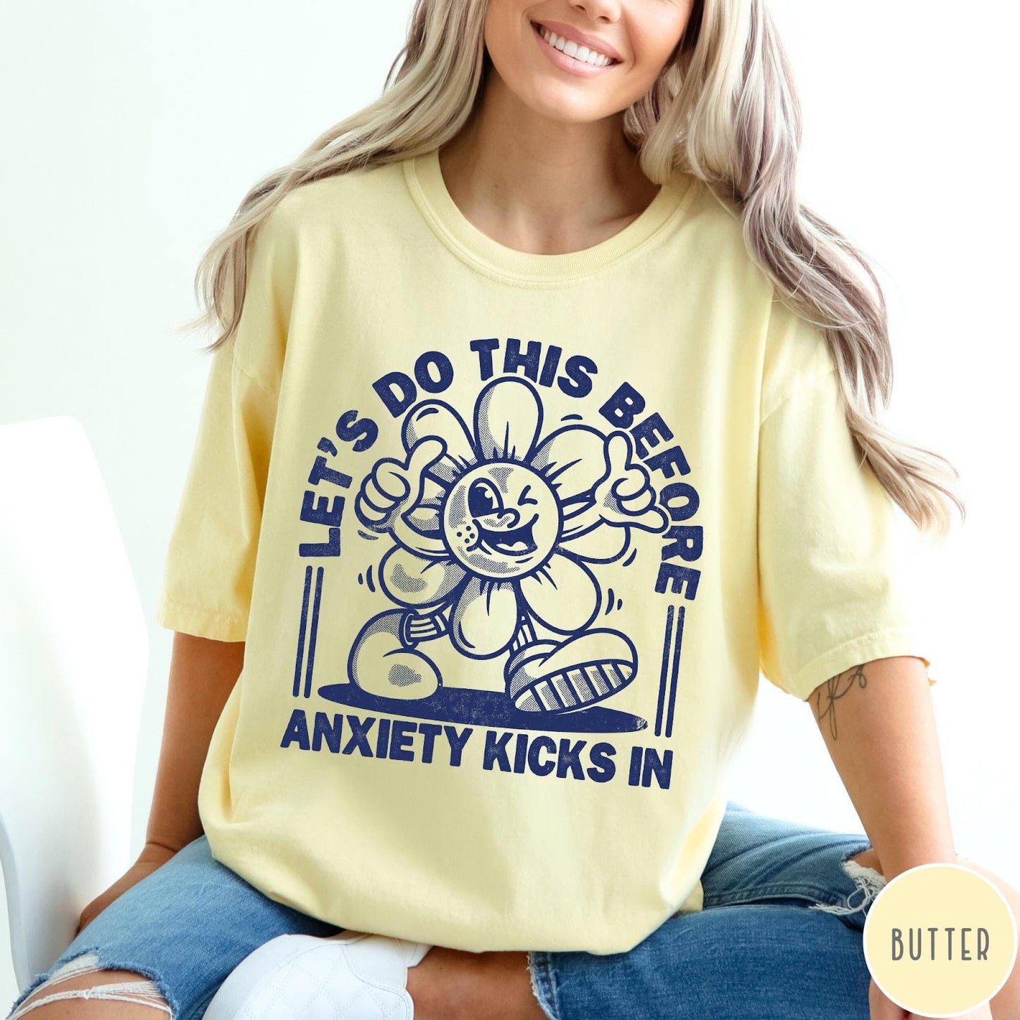 Comfort Colors tee in Butter featuring retro graphic style winking flower character with anxiety text design