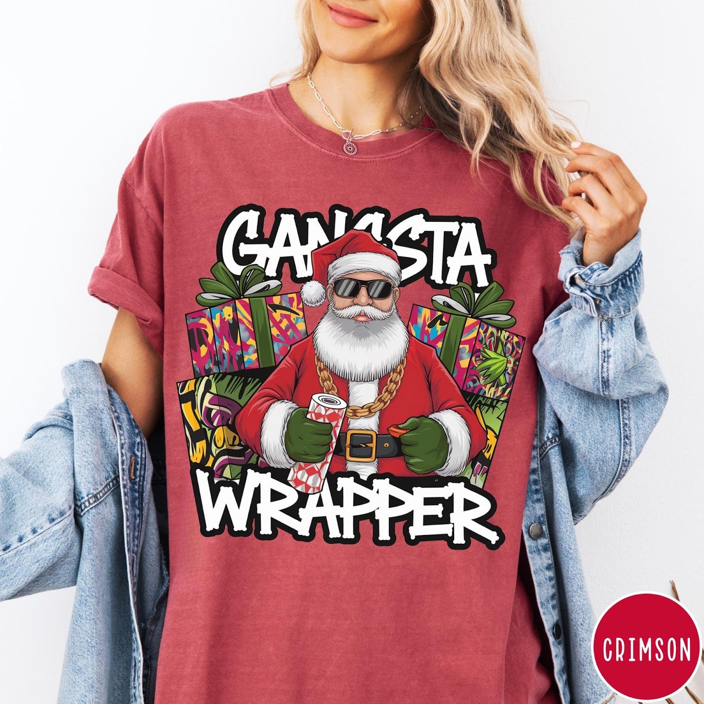 Comfort Colors tee in Crimson featuring cartoon style Santa Claus wearing sunglasses and gold chain holding wrapping paper