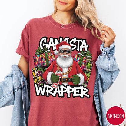 Comfort Colors tee in Crimson featuring cartoon style Santa Claus wearing sunglasses and gold chain holding wrapping paper