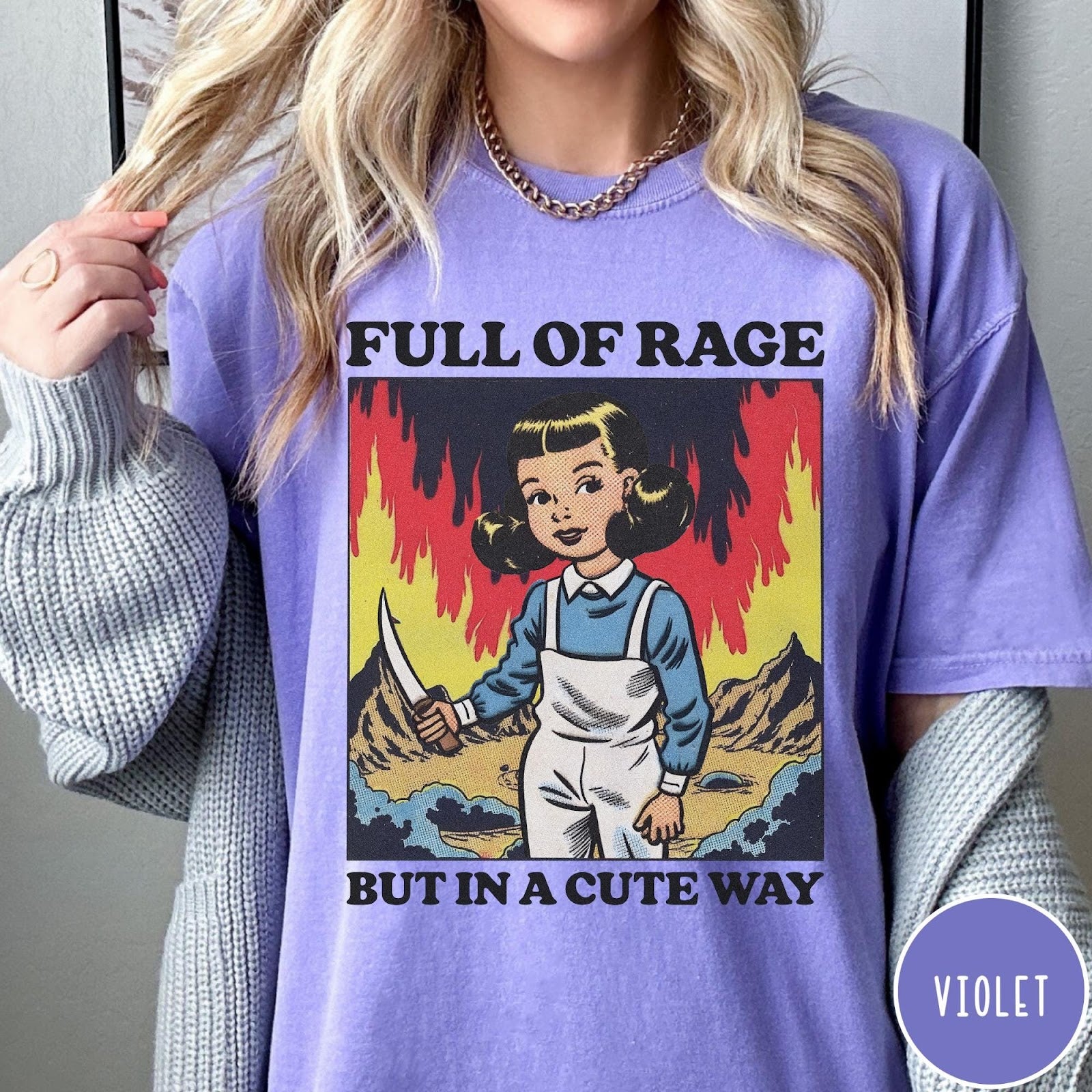 Comfort Colors tee in Violet featuring cartoon style graphic of a girl holding a knife in flames