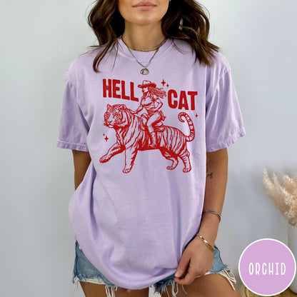Comfort Colors tee in Orchid featuring western style graphic of a cowgirl riding a tiger