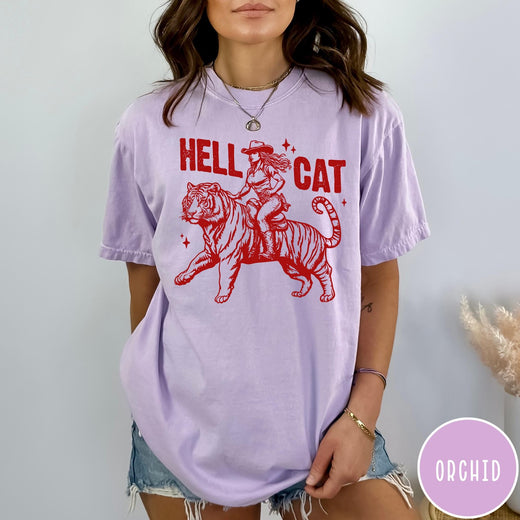 Comfort Colors tee in Orchid featuring western style graphic of a cowgirl riding a tiger