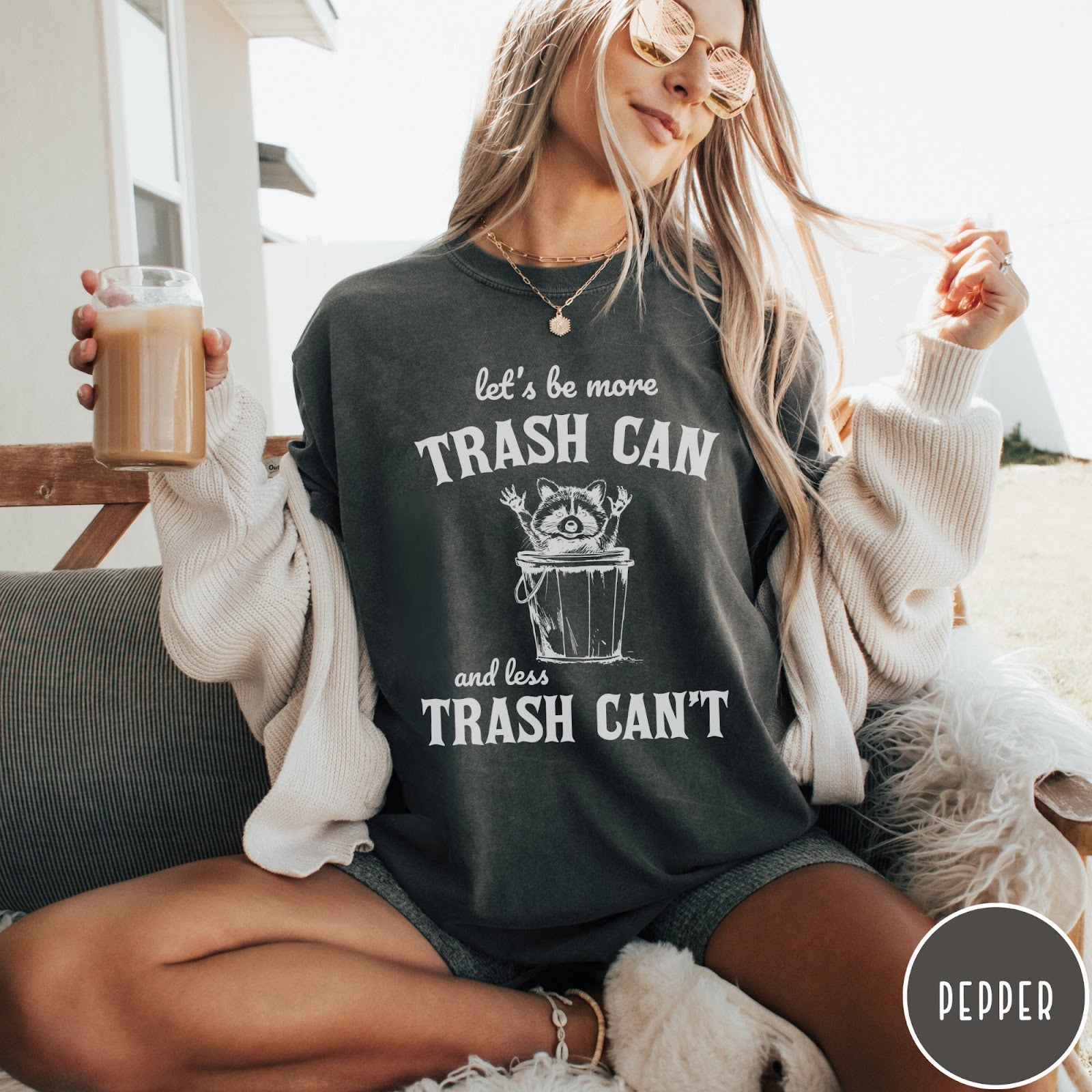 Comfort Colors tee in Pepper featuring casual graphic style with a raccoon inside a trash can illustration