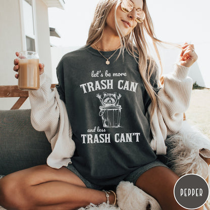 Comfort Colors tee in Pepper featuring casual graphic style with a raccoon inside a trash can illustration