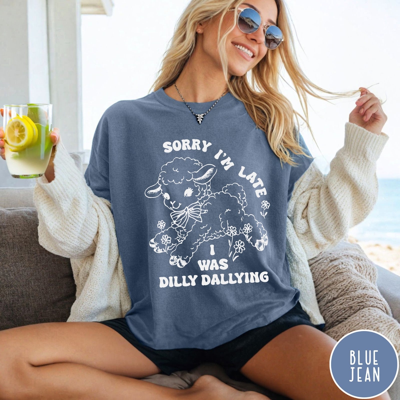 Comfort Colors tee in Blue Jean featuring line art graphic of a lamb with flowers and text