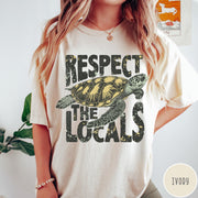 Comfort Colors tee in Ivory featuring vintage style sea turtle graphic with Respect the Locals text