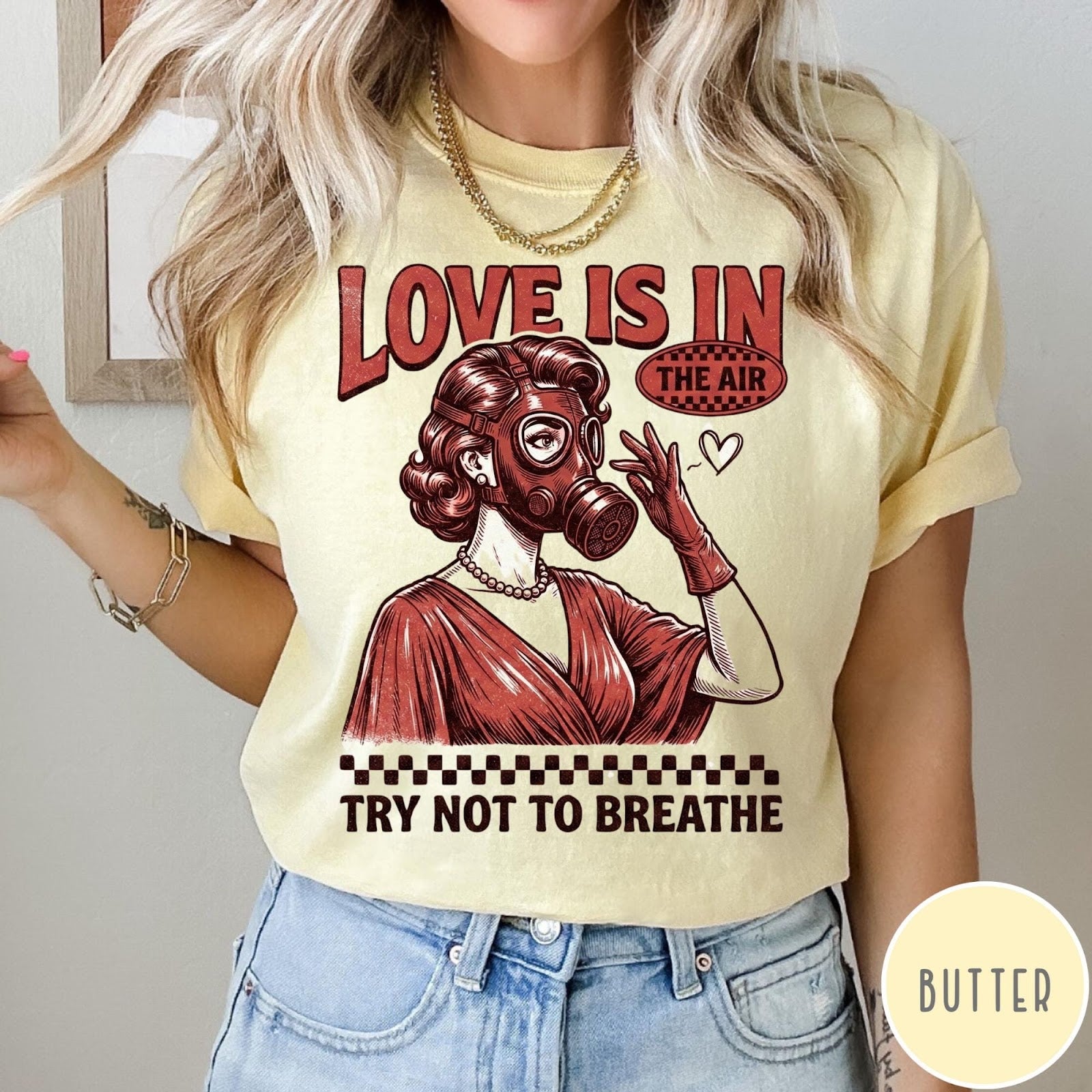 Comfort Colors tee in Butter featuring retro style graphic of a woman wearing a gas mask